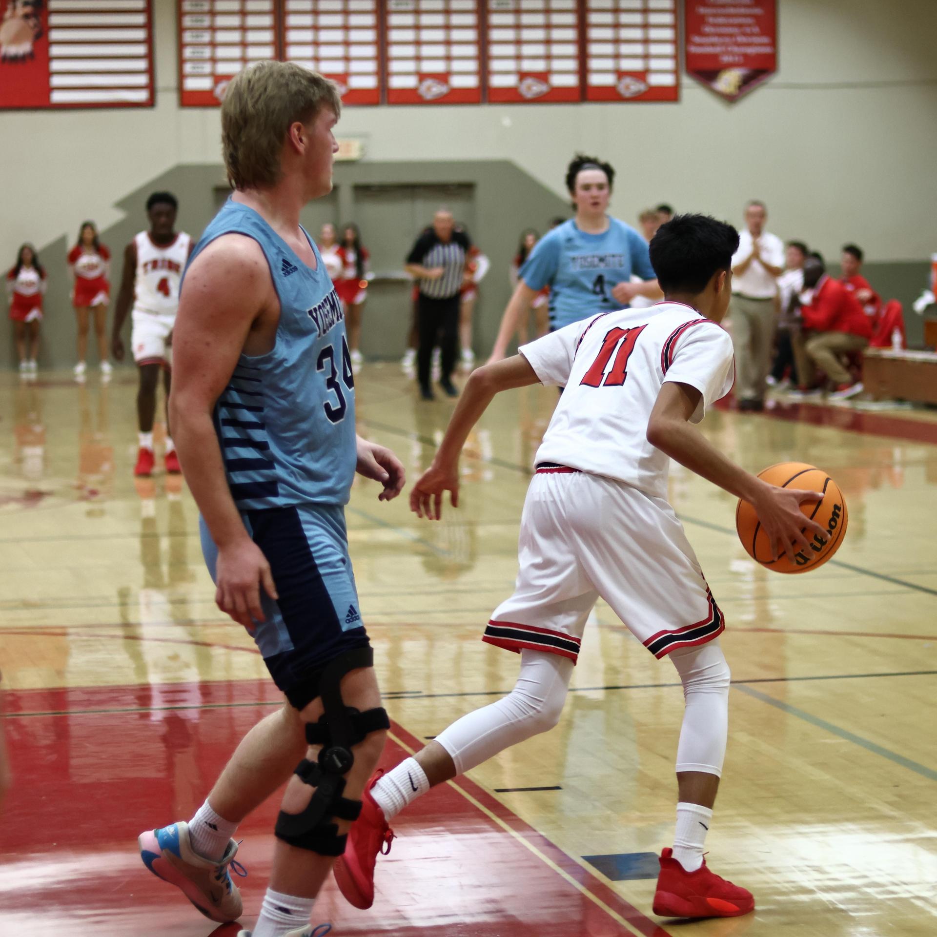 Varsity boys playing basketball against yosemite