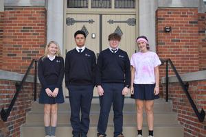 the October OLSH students of the month standing on the front steps of the school