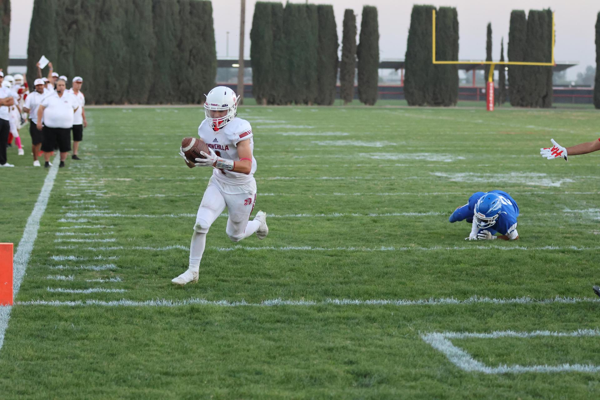 Junior Varsity football players in action against Caruthers