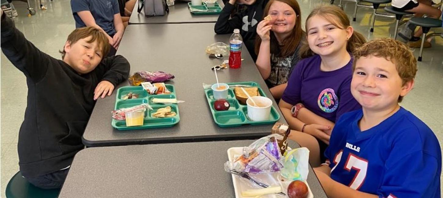 Happy students at a lunchroom table