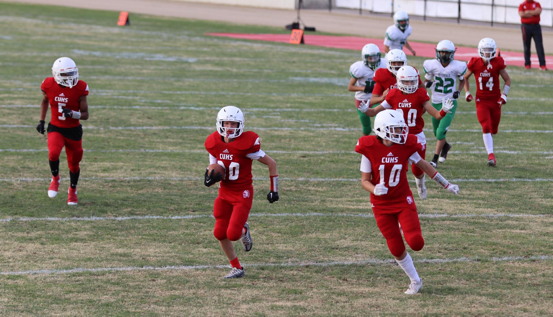  junior varsity football players in action against riverdale