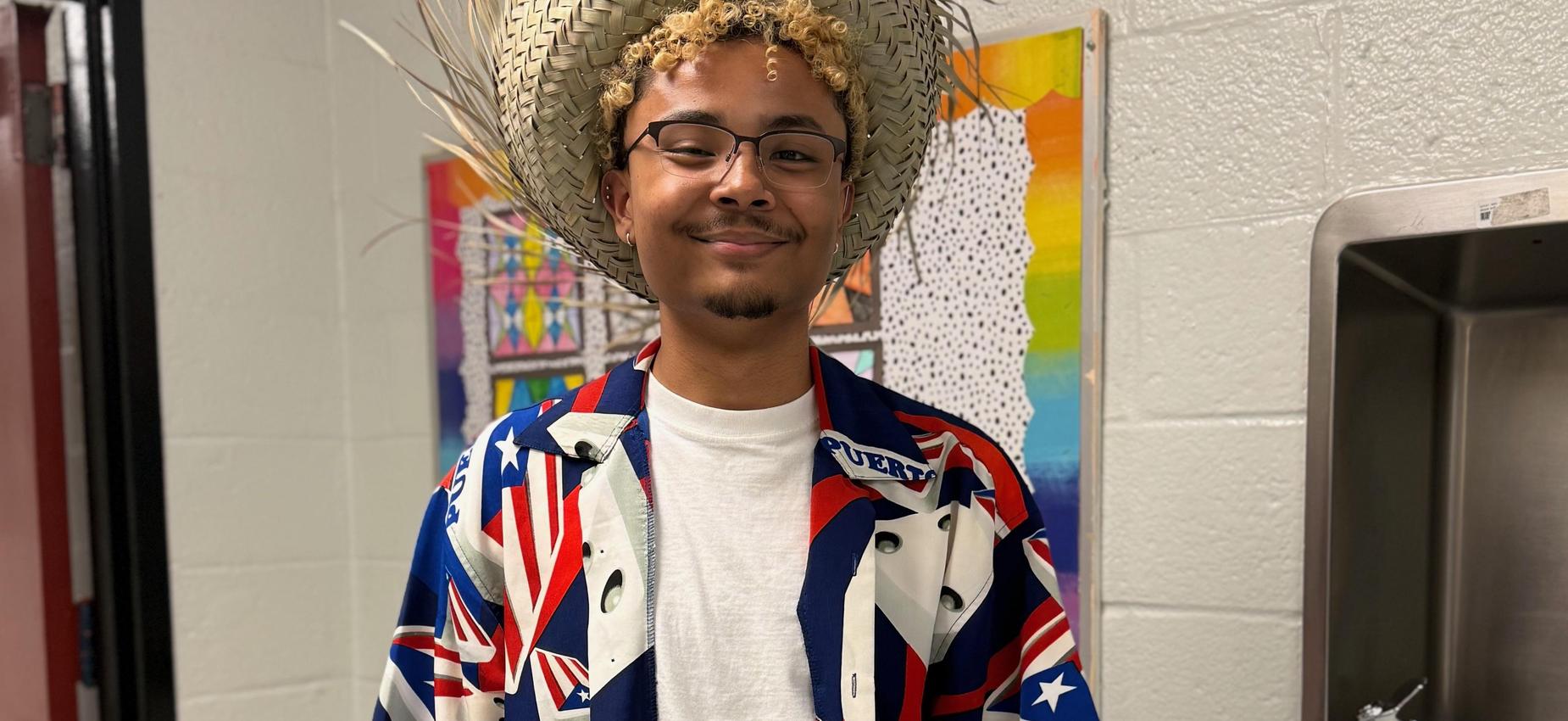 Student wearing a straw hat and Hawaiian shirt