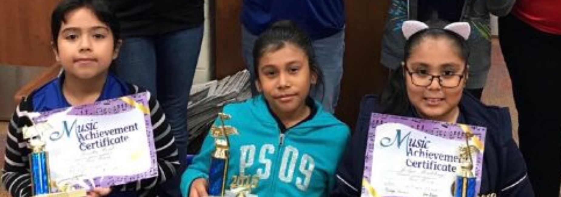 3rd graders show off their certificates and trophies for music memory.