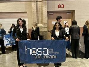 Smiling teens dressed in professional attire