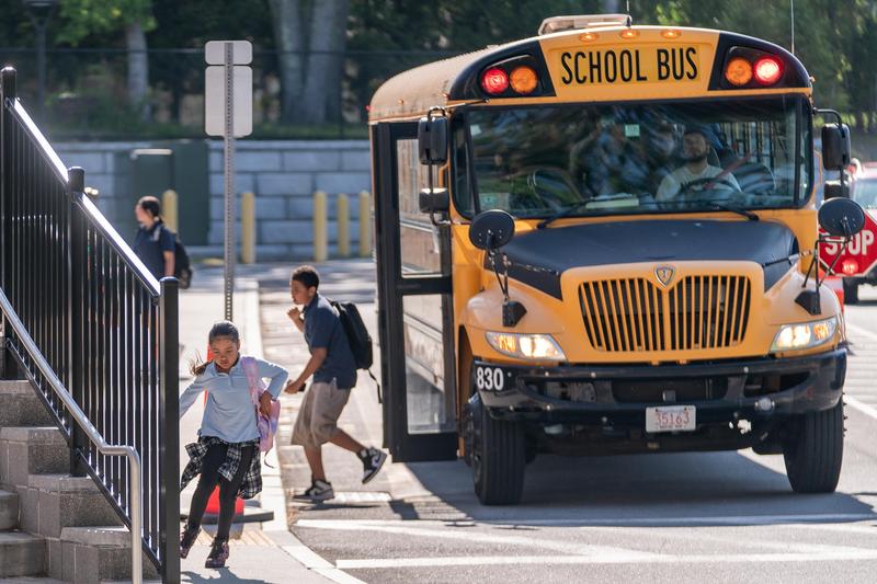Alma scholars disembark a school bus outside of school