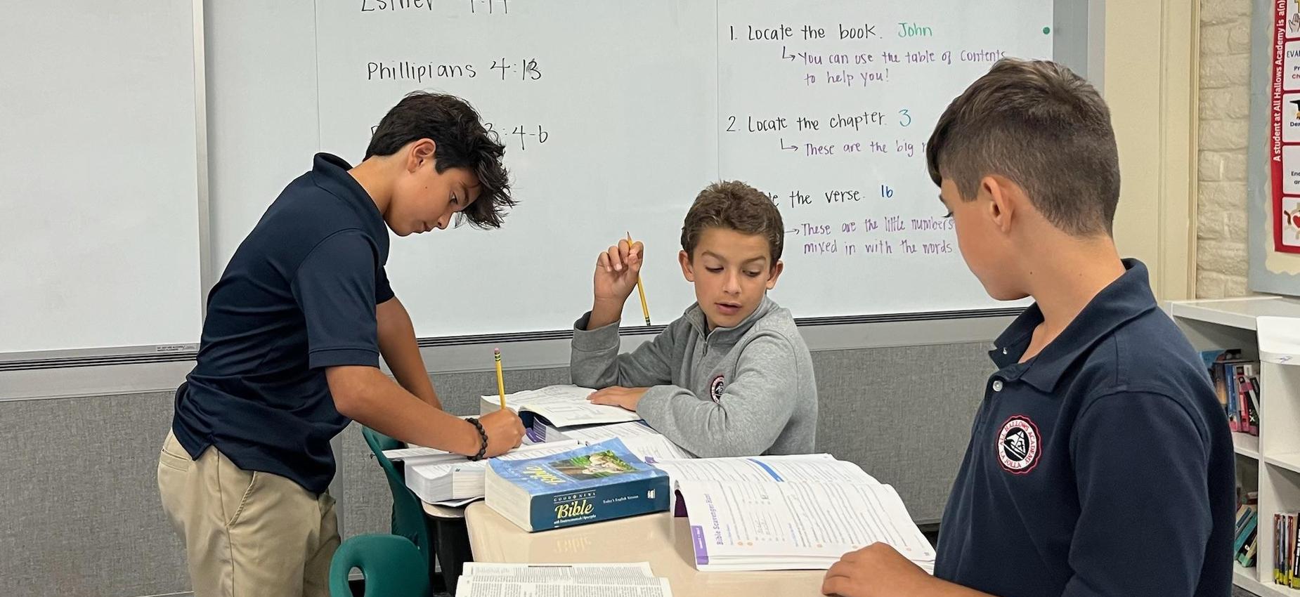 3 students locating scriptures in the bible