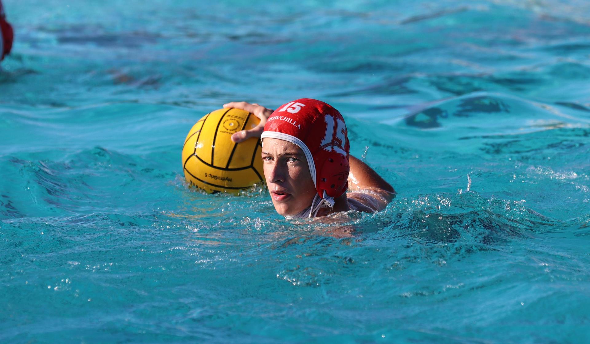 boys water polo players in action against hoover