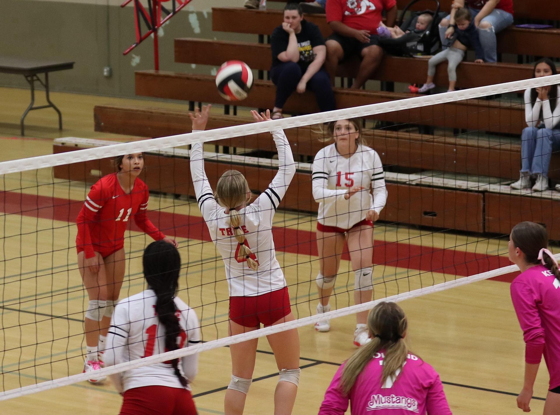 varsity volleyball players in action against Minarets