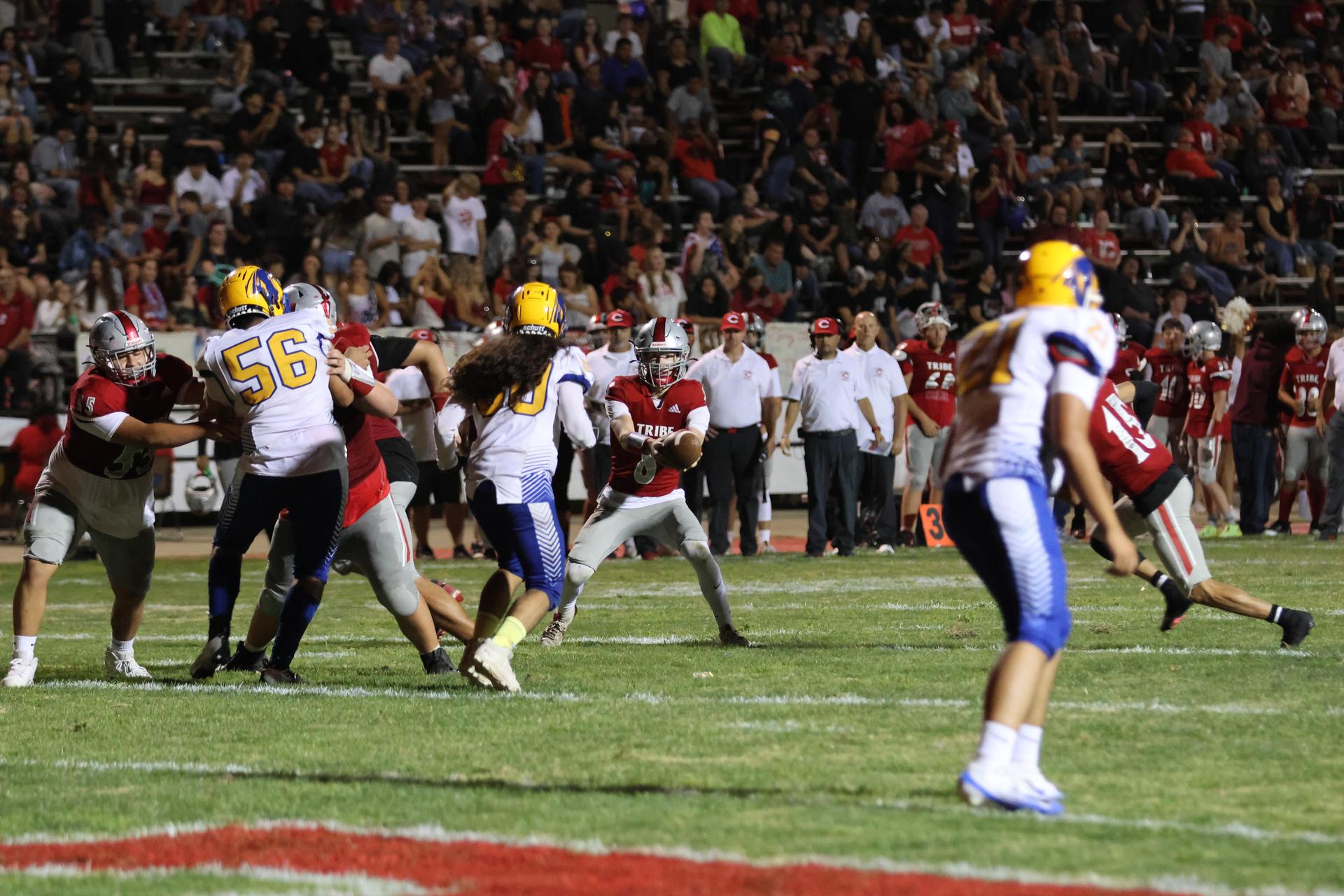 Varsity football players in action against Parlier 62