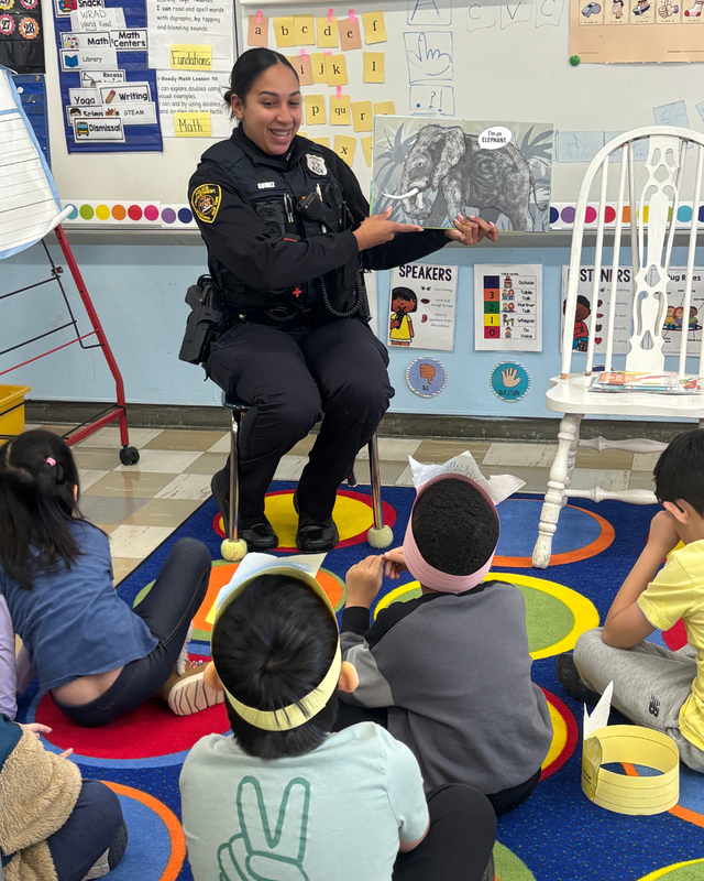 Police officer reading to students