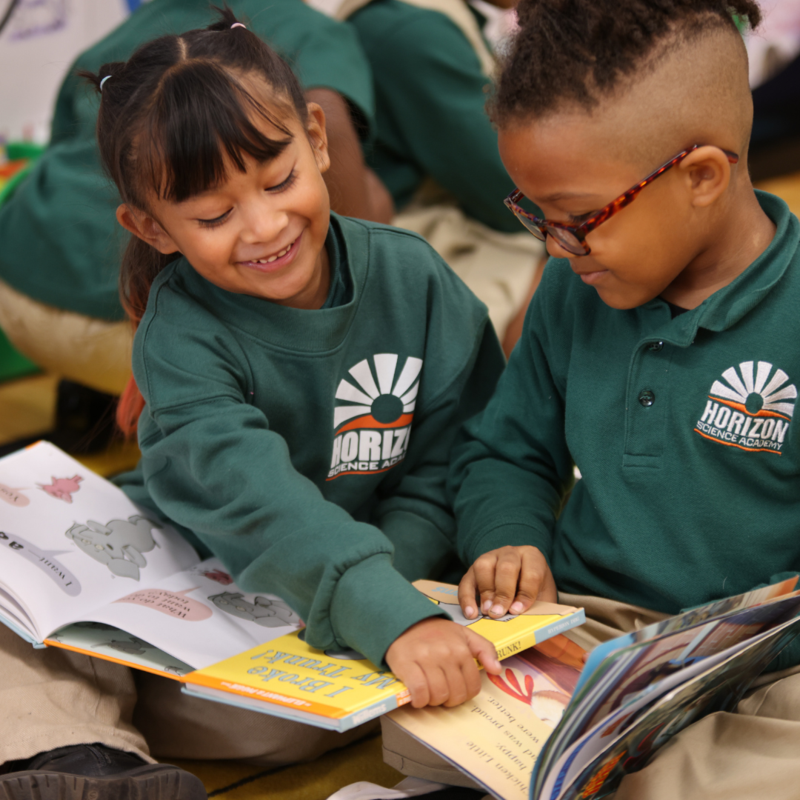 Two HSA Des Moines students reading book