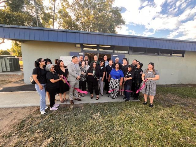 Ribbon cutting ceremony with attendees