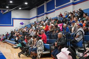 Family and community members watch the ceremony