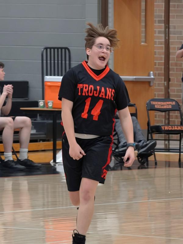 A student celebrates after making a basket.