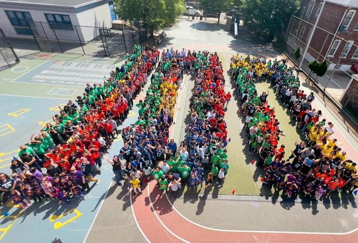Photo of children in the shape of the number 100.