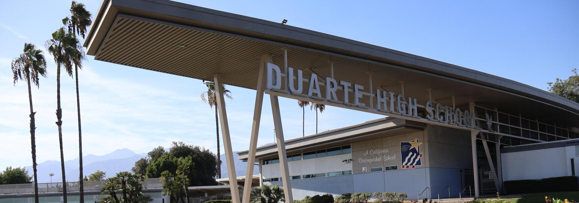 Exterior view of Duarte High School with landscaping and palm trees.