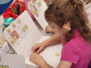 A student changes a word on her word-board