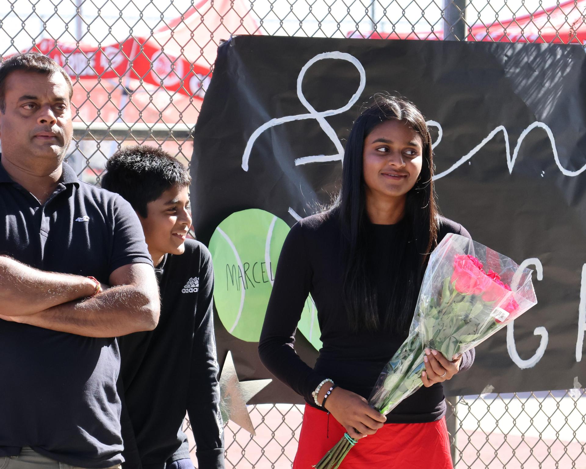 tennis players, family, and staff celebrating senior night