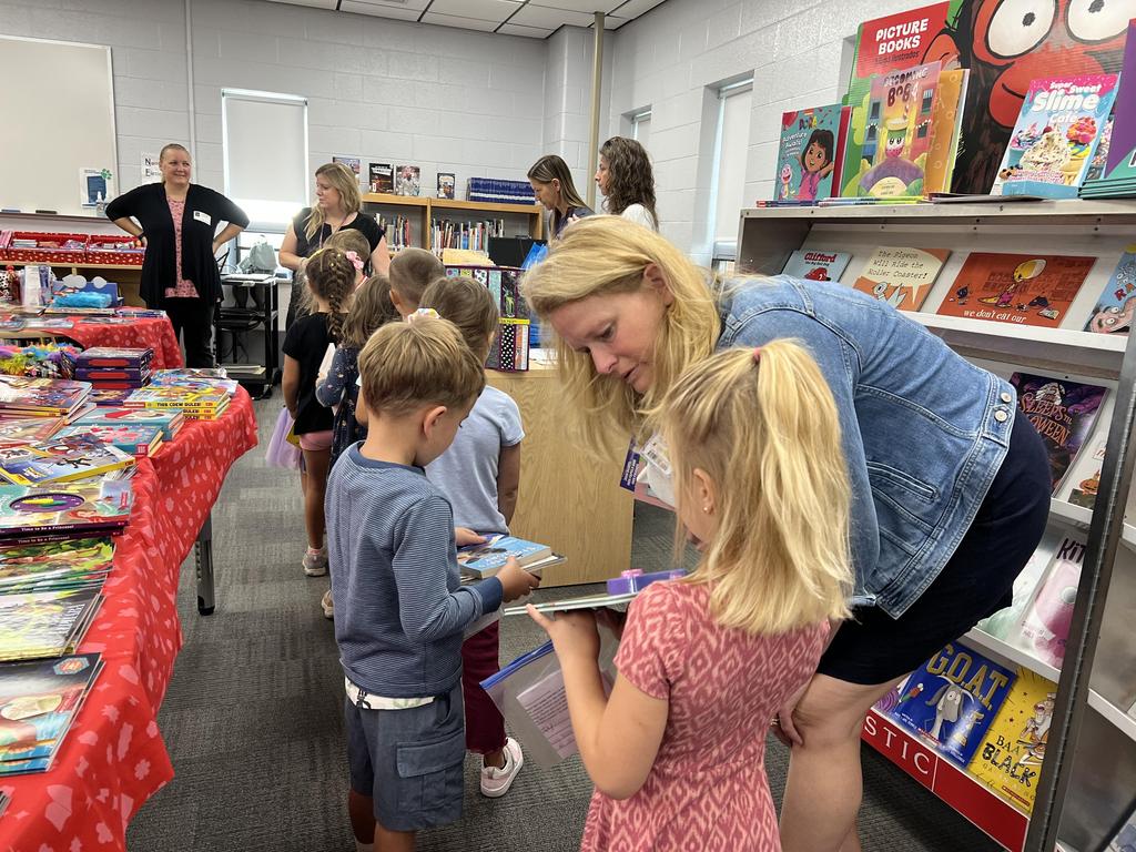 Dr. O'Connell speaking with students at the book fair.