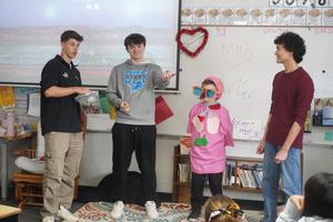 Three high school students help a Page Elementary student display affects of tobacco on the body.