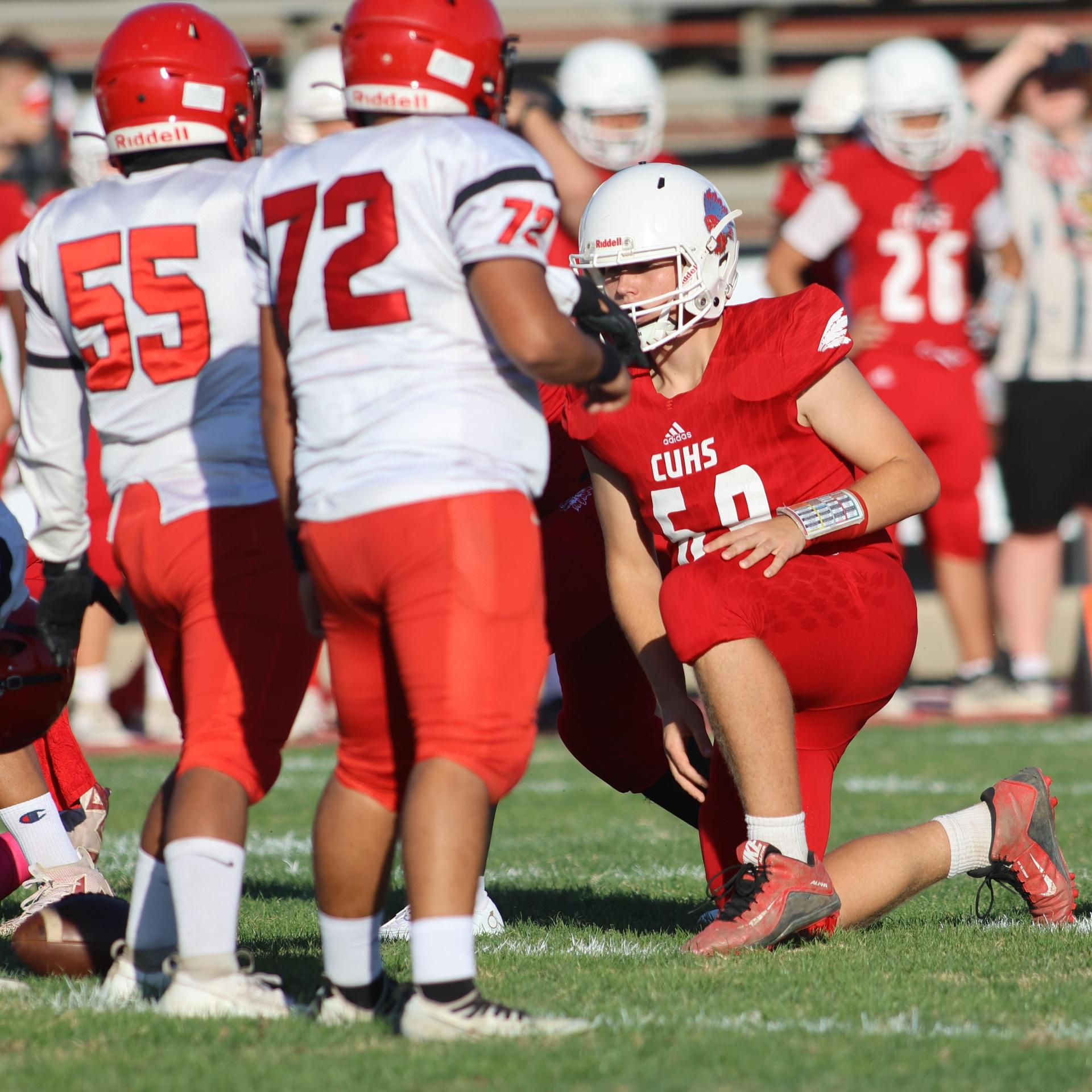 junior varsity football players in action against Fowler