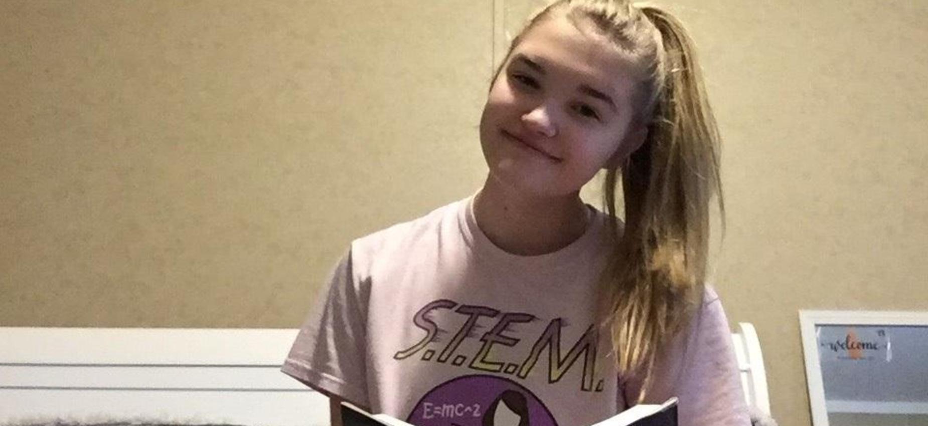 A student reads in her pajamas.