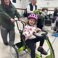 Carmen and Gabby wear matching red t-shirts while discussing Gabby's new bike.