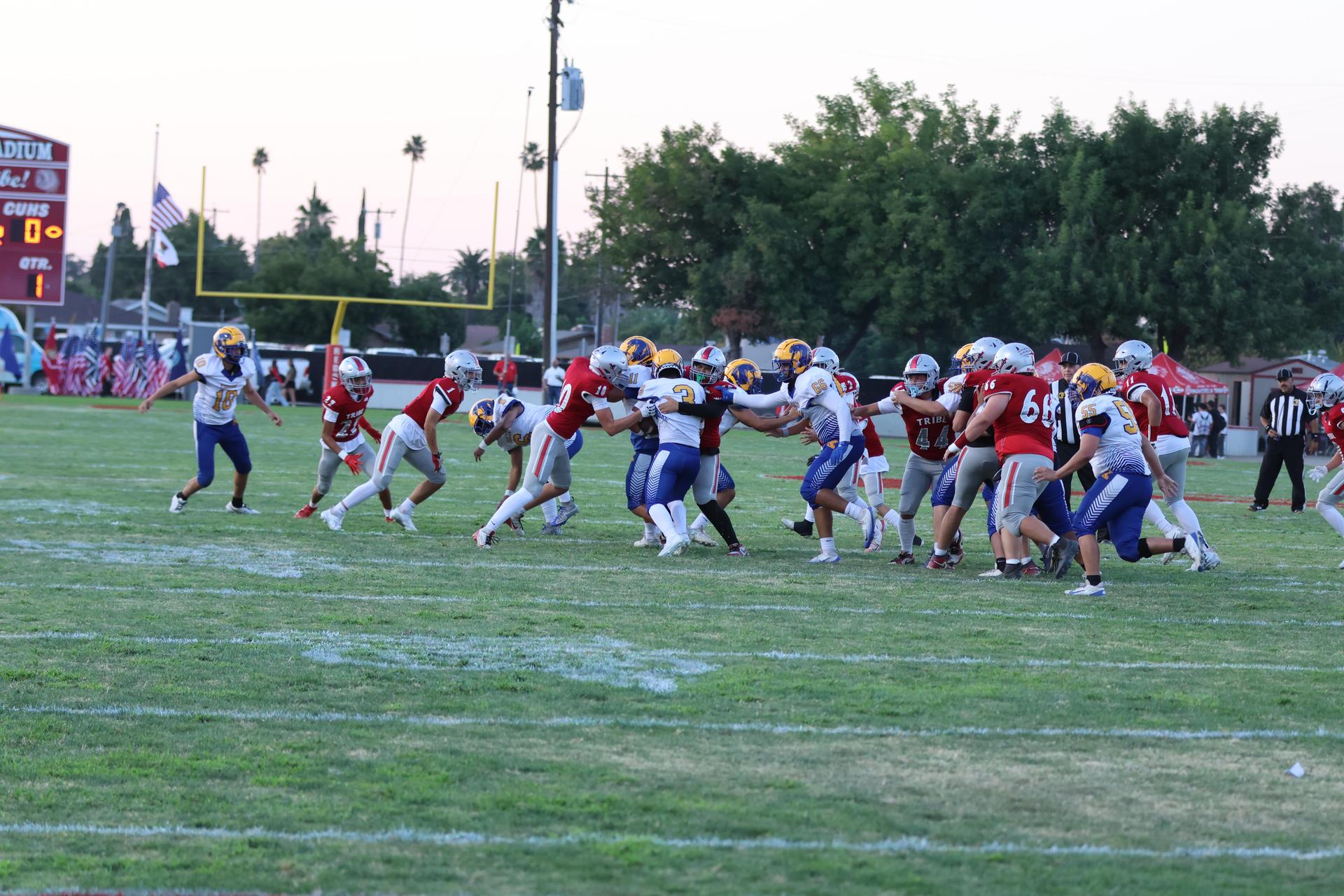 Varsity football players in action against Parlier 1