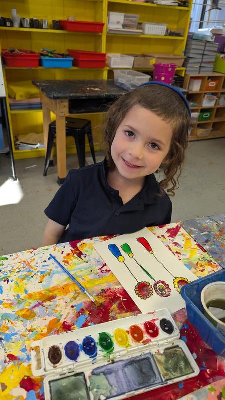 First grade boys work on watercolor vases