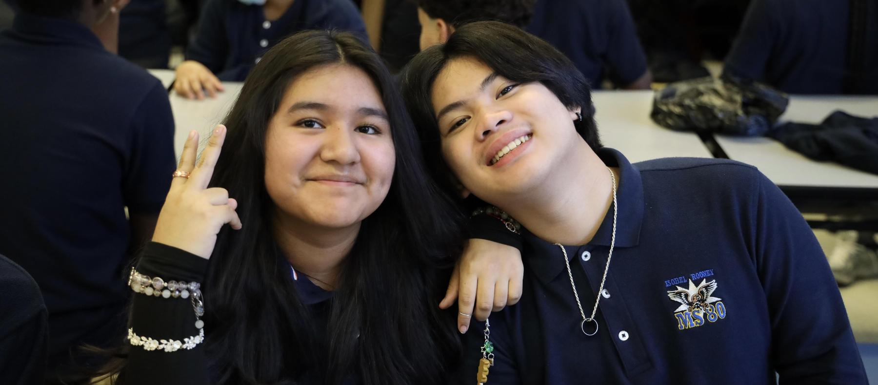 Two friends smiling and posing together