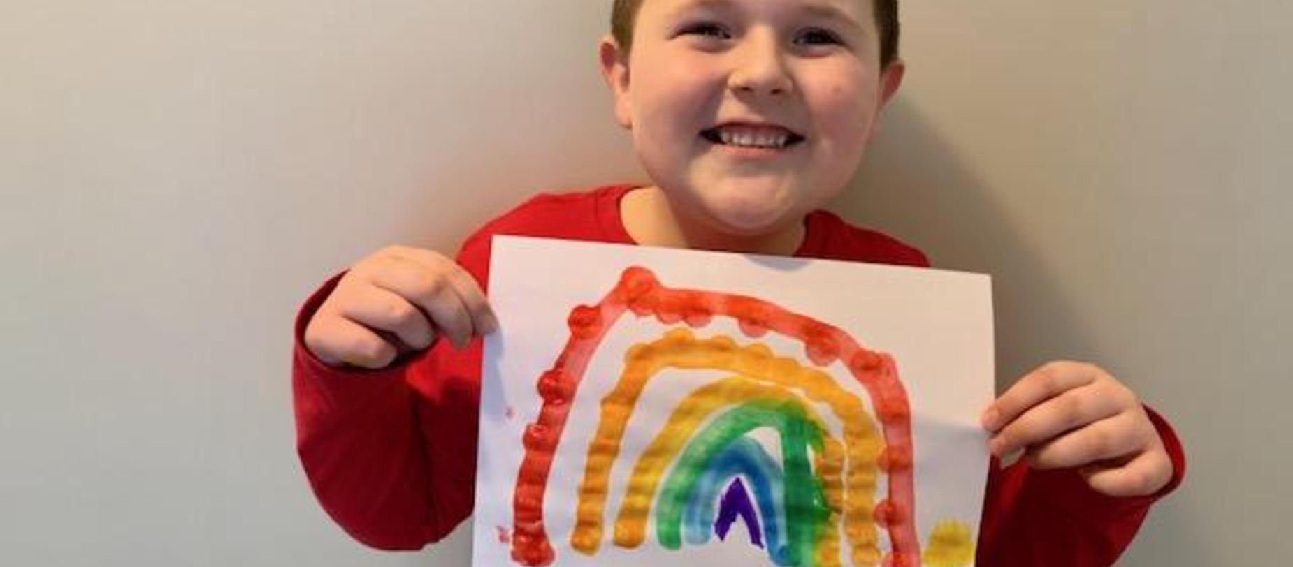 student with rainbow picture
