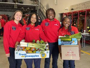 students smiling holding food boxes
