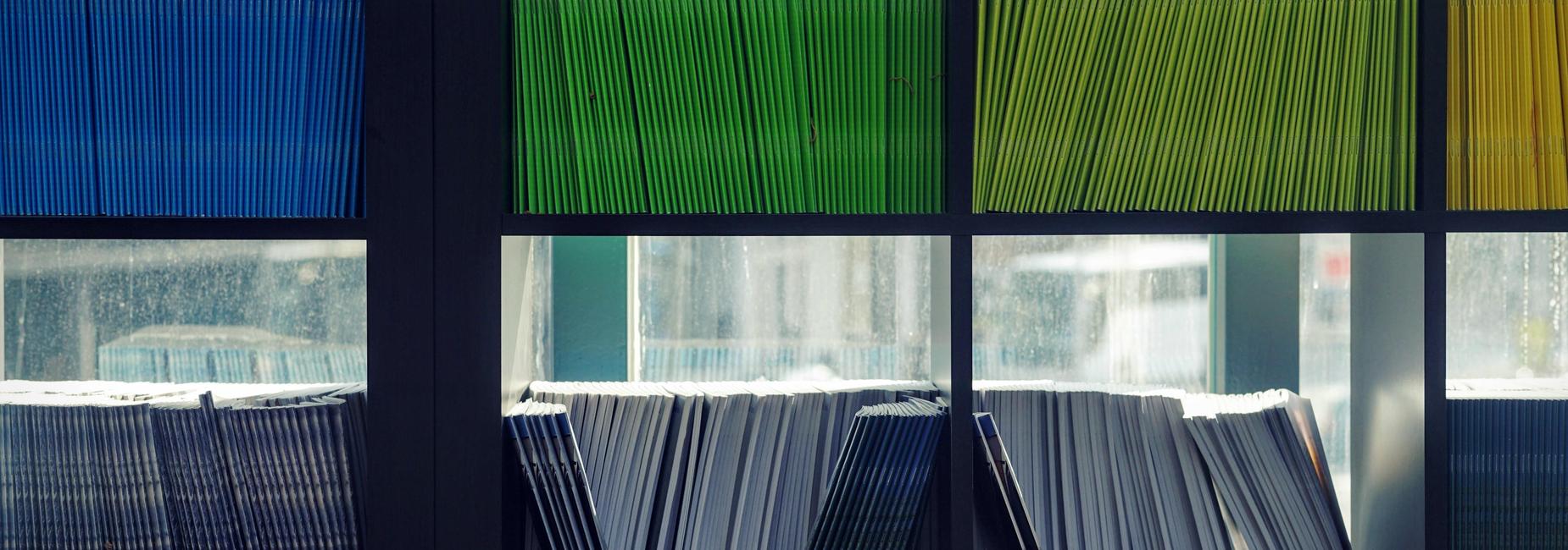 Shelves filled with neatly organized colorful folders.