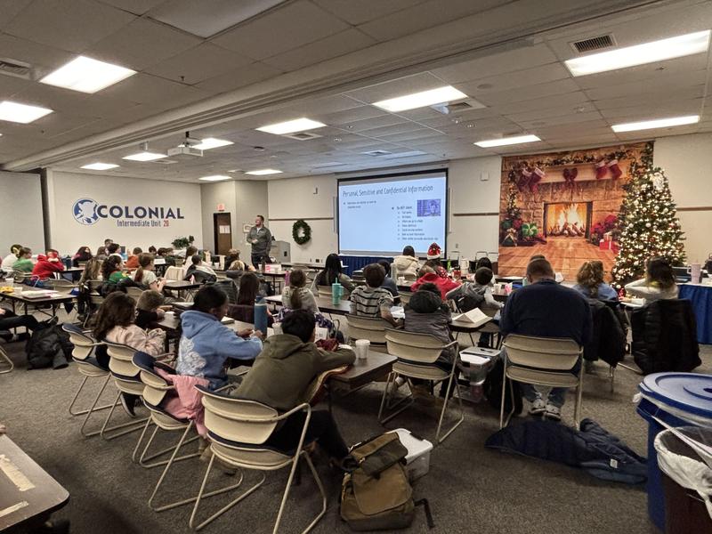 James Stout presenting to group of about 50 students who are sitting down.