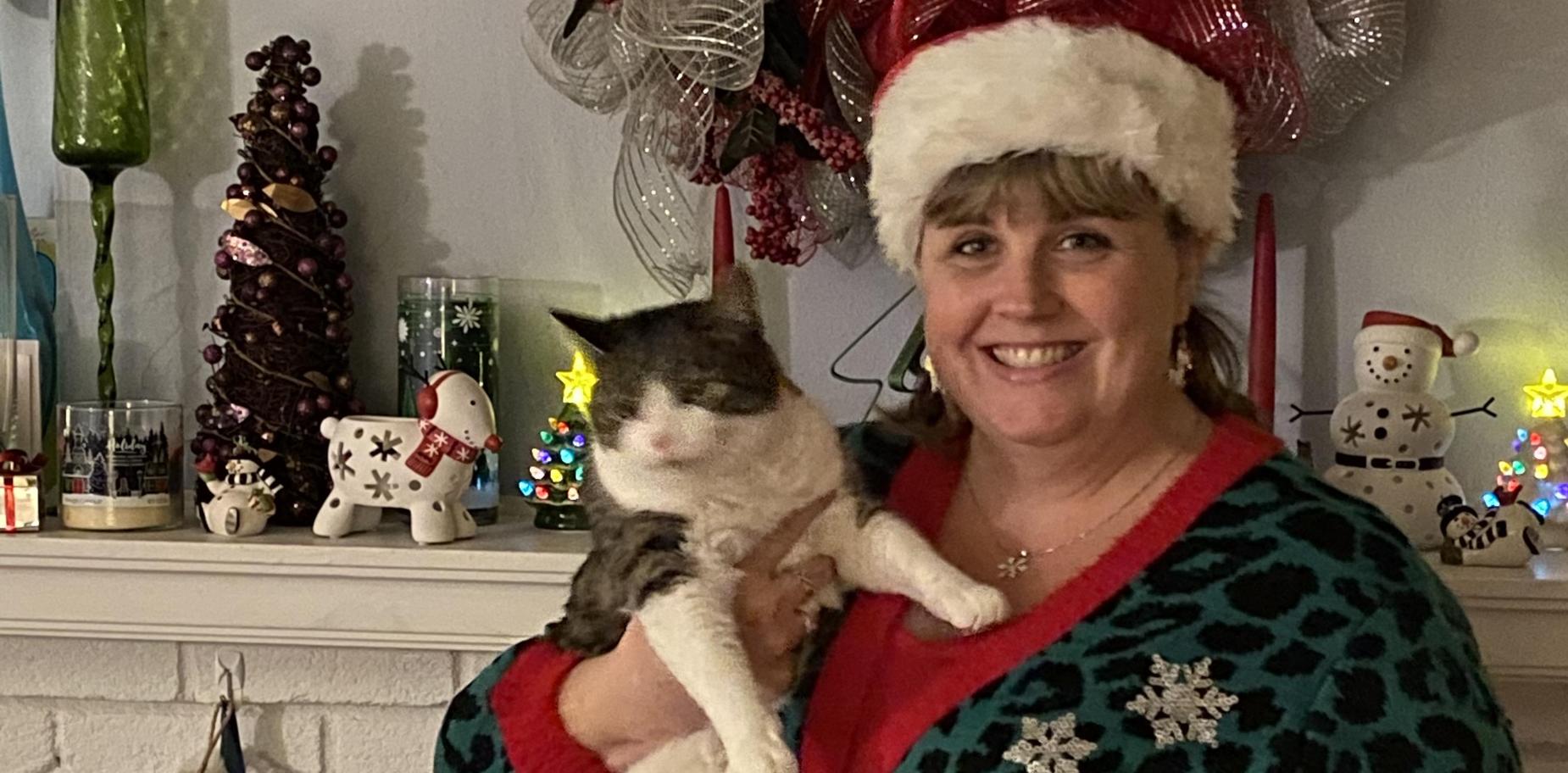 Teacher in Christmas attire with cat