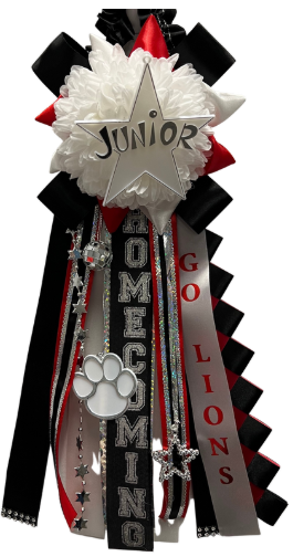 A black, red, and white homecoming mum with streamers