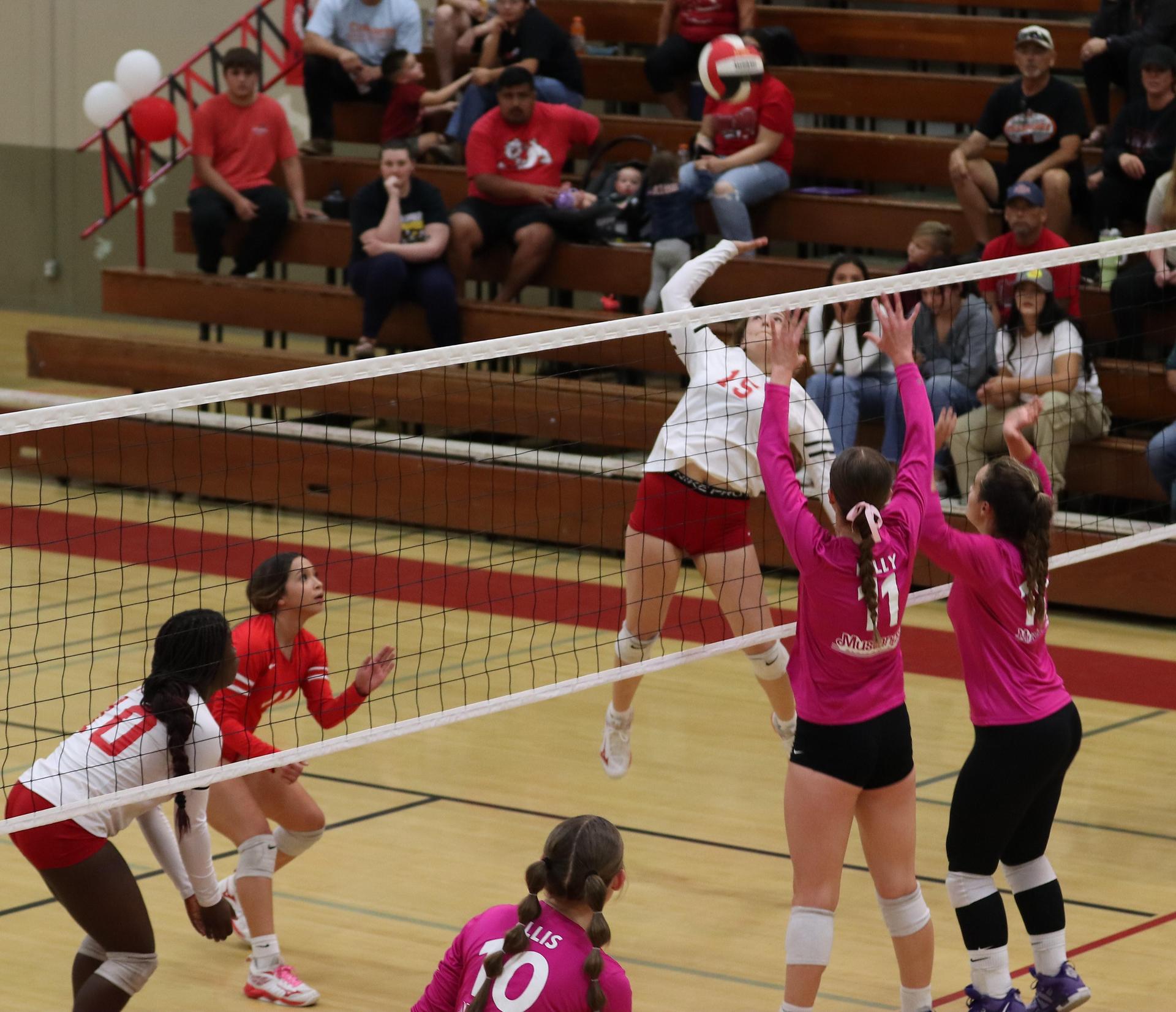 varsity volleyball players in action against Minarets