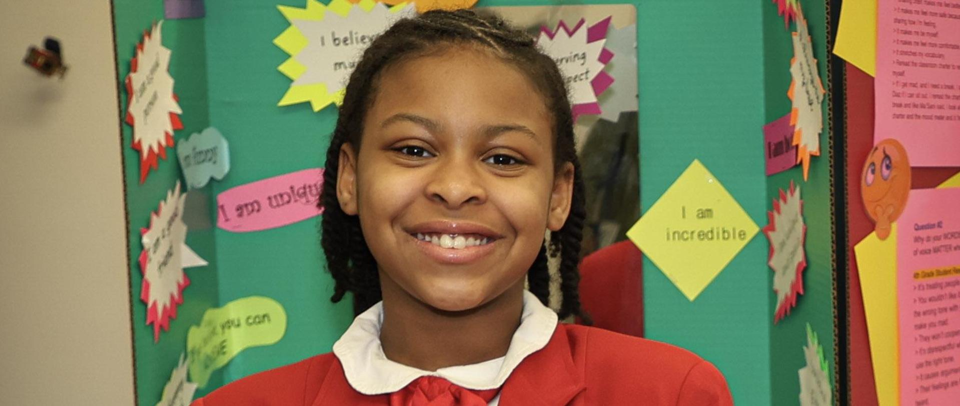 Student standing in front of presentation