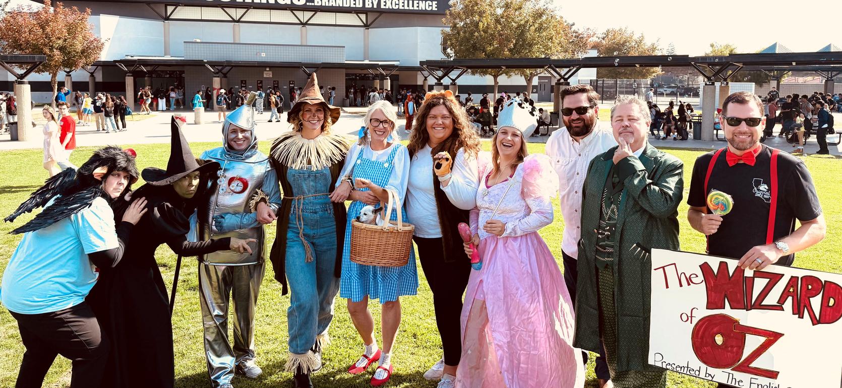 Group of people in costume representing characters from The Wizard of Oz at an outdoor event.