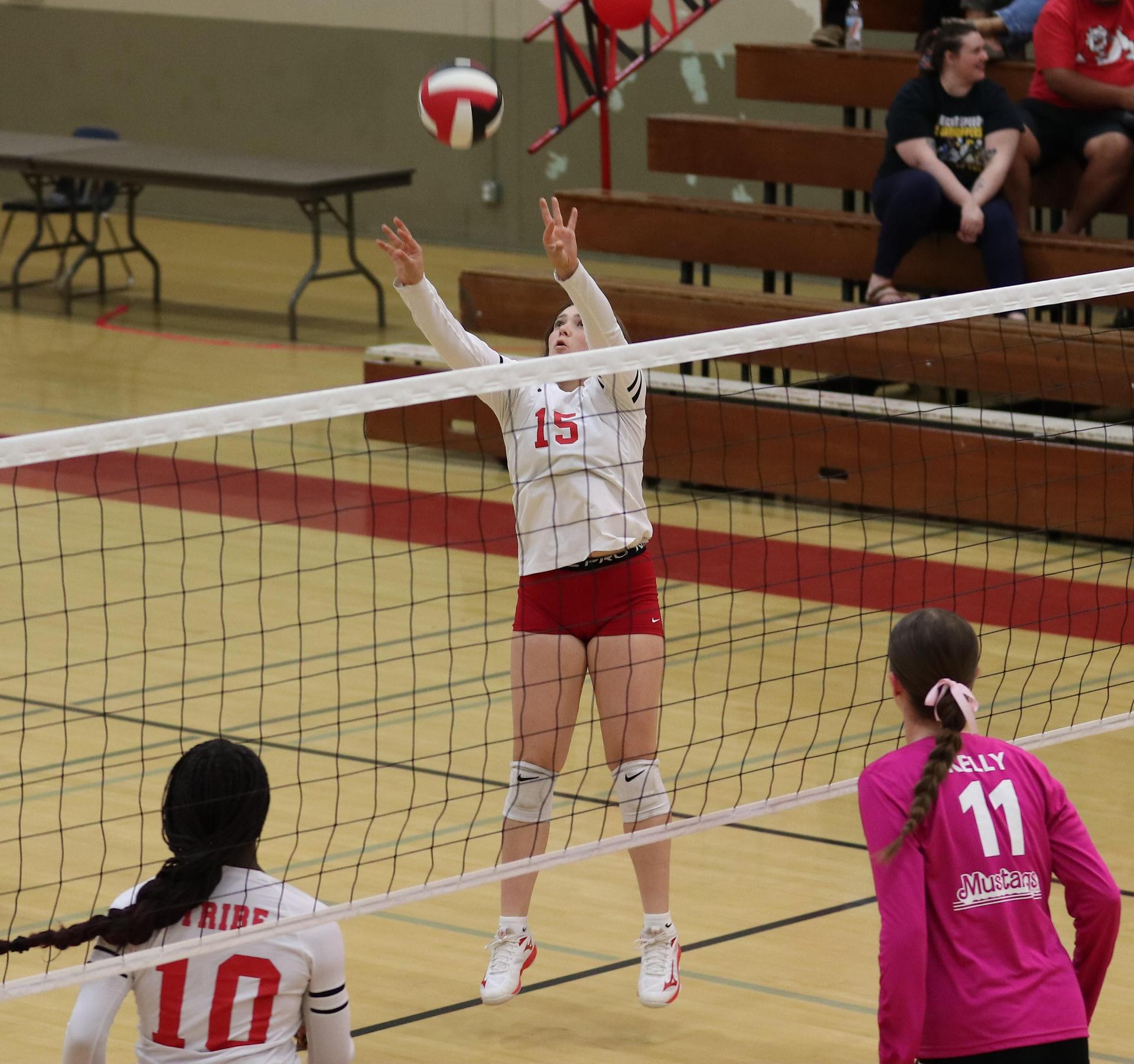 varsity volleyball players in action against Minarets