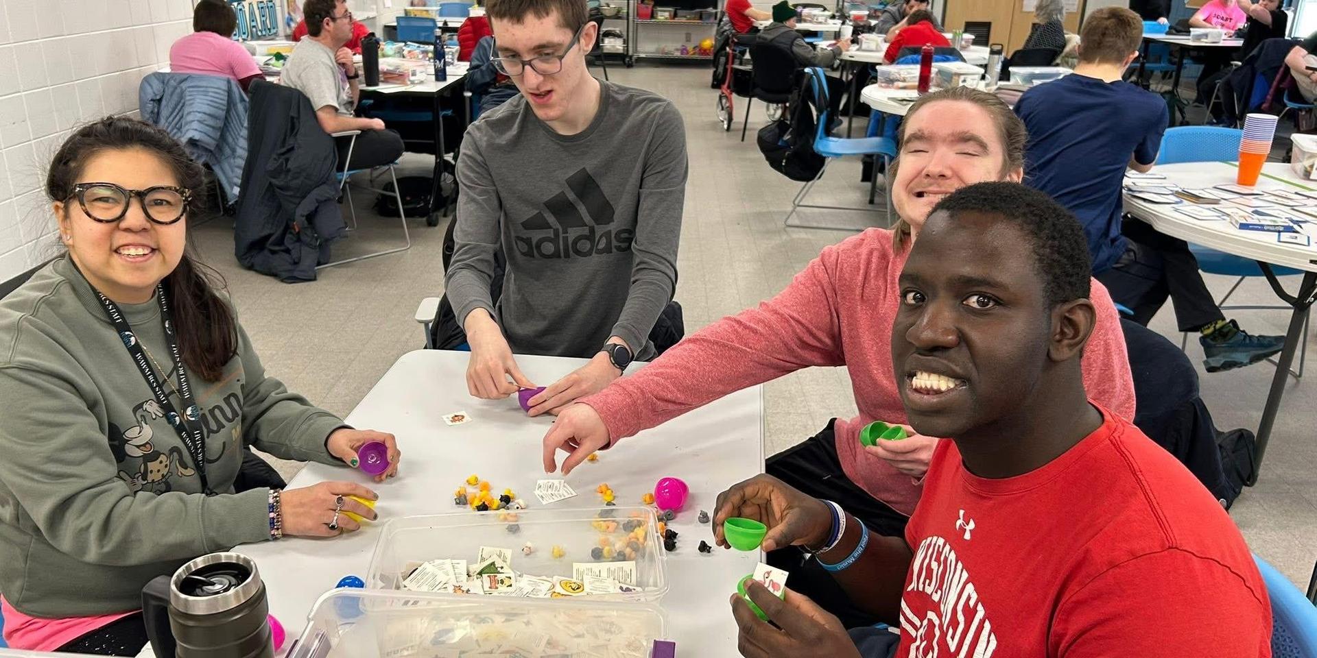 A group of young adults enjoying games around a table.