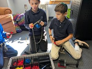 Fourth grade students familiarize themselves with a robotics kit.