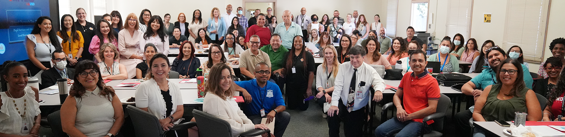 Large group of LAUSD staff members posing together during a meeting