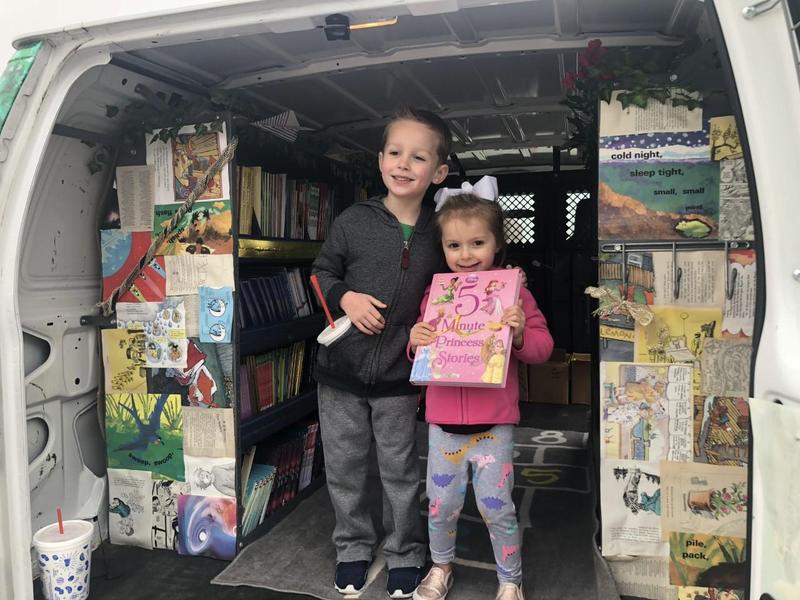 two students pose with books