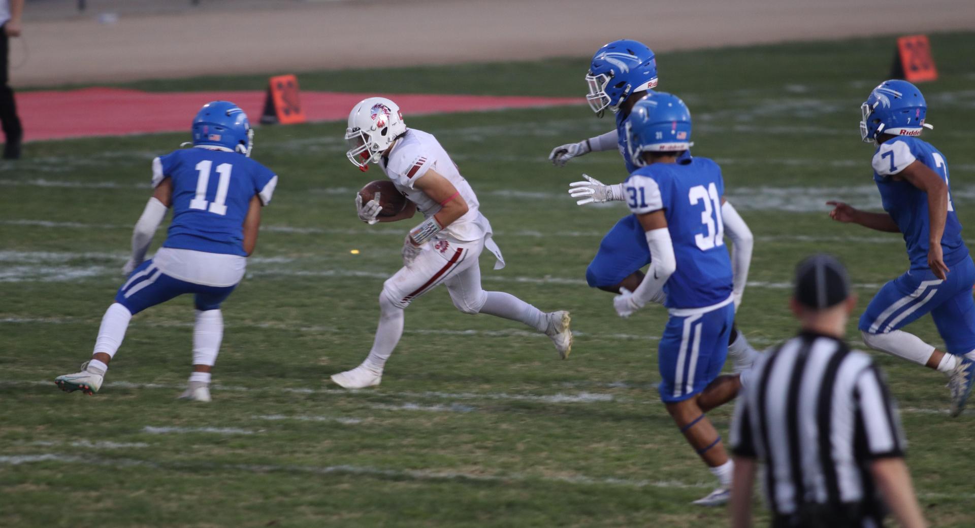 Junior Varsity football players in action against Caruthers