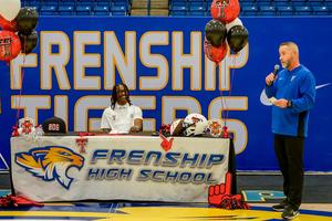 chase campbell athletic signing at table coach jay northcutt talks near table