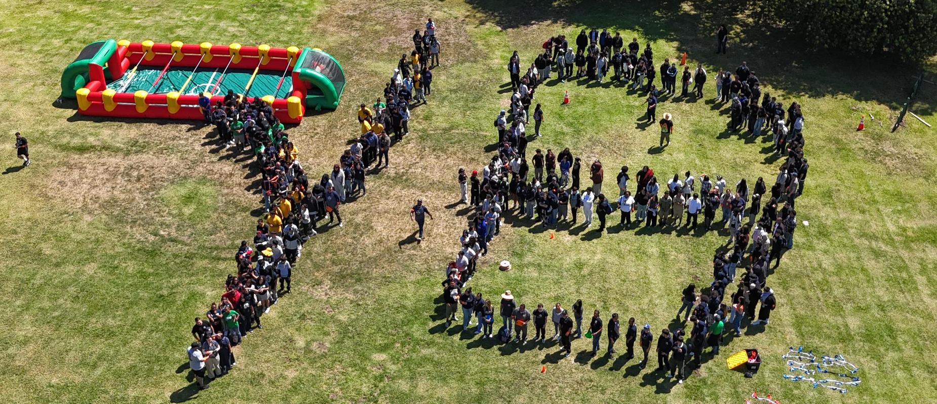 Students form a large Y and B in a drone photo