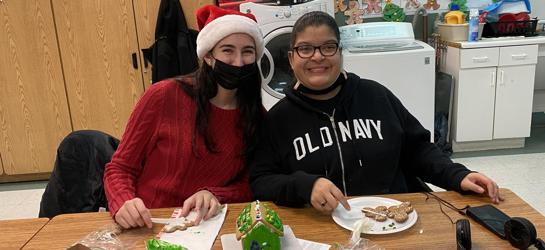 Students decorating gingerbread houses for Christmas