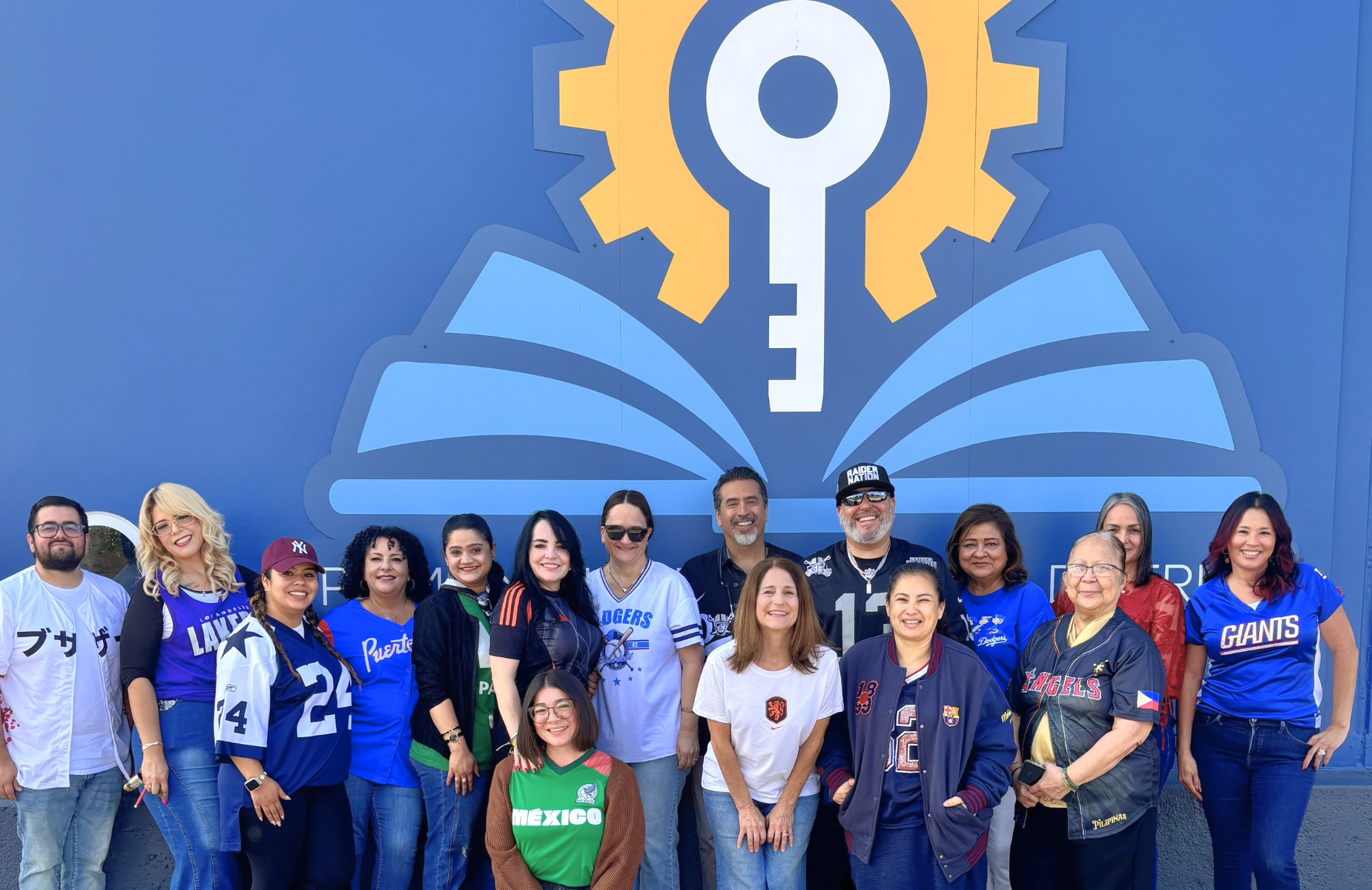 September Spirit at Adult & Career Education- Shuffle banner of ACE team in front of their campus sign.