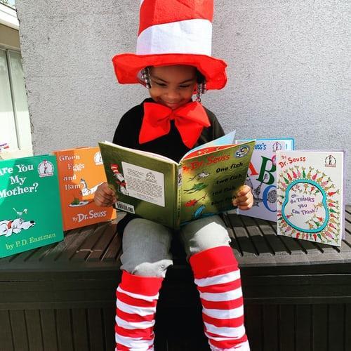 Student reading a Dr. Seuss book